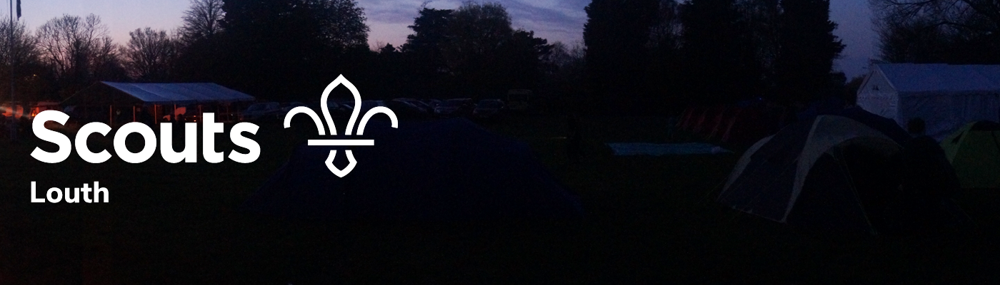 Panoramic of a campsite in the dark, you can see some tents and plenty of ambiance